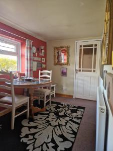 a kitchen with a table and chairs and a dining room at Littlebeck in Danby