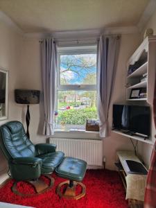a living room with a chair and a window at Littlebeck in Danby