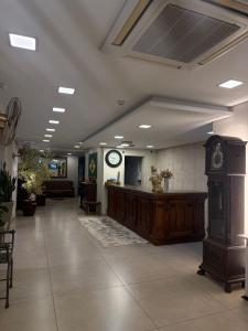 a waiting room with a clock on the wall at Hotel São Luiz in São Gabriel +11 photos