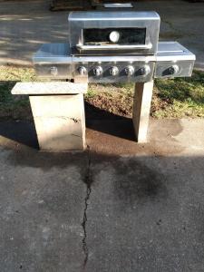 a stove sitting on top of a concrete table at Town Square Charm Century Old in Lewisville
