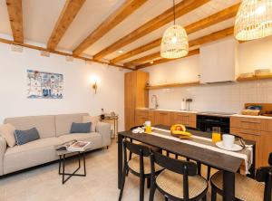 a kitchen and living room with a table and a couch at Villa Jele in Dubrovnik