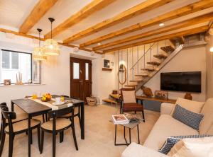 a living room with a table and a couch and a tv at Villa Jele in Dubrovnik