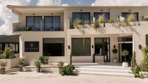 a house with a lot of plants in front of it at La Mirage Hotel in Tsilivi
