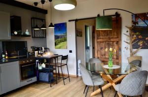 a kitchen with a glass table and chairs and a counter at Matilde House in Fanano +20 photos