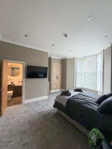 a bedroom with a large bed and a bathroom at 4 James street in Selby