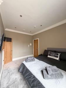 a bedroom with a large bed with two towels on it at 4 James street in Selby