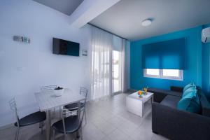 a living room with a couch and a table at Fresh Mare Apartments in Limenaria +20 photos