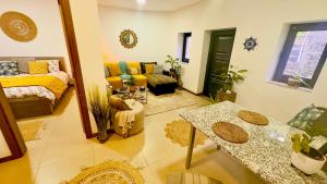 a living room with a couch and a table at Wylde Roots River House - with natural river swimming pools in Couto de Baixo