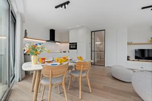 a kitchen and dining room with a table and chairs at Baldus 0401 P47 in Sint-Idesbald +15 photos