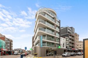a tall building with cars parked in front of it at Baldus 0401 P47 in Sint-Idesbald