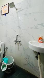 a bathroom with a sink and a toilet at The Cozy Nest in Gurgaon +5 photos
