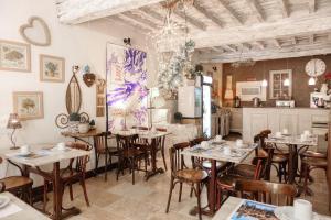 a restaurant with tables and chairs and a kitchen at Hôtel Boquier, Avignon Centre in Avignon