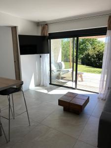 a living room with a large sliding glass door at Cocon proche de Lyon in Neyron