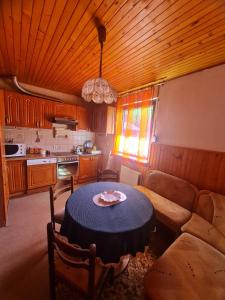 a living room with a table and a couch at Apartmani Bistrivoda in Vogošća