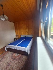 a bedroom with a bed with a wooden ceiling at Apartmani Bistrivoda in Vogošća