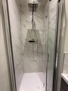 a bathroom with a shower with a glass door at 4 James street in Selby