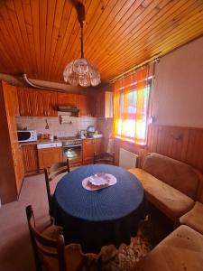a kitchen with a table with a plate on it at Apartmani Bistrivoda in Vogošća +13 photos