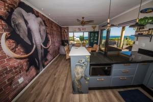 a kitchen with a mural of an elephant on the wall at The Butterfly Villa in Pringle Bay