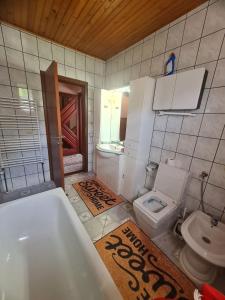 a bathroom with a bath tub and a toilet at Apartmani Bistrivoda in Vogošća