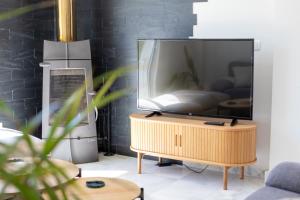 a tv sitting on a table in a living room at Jacarandas Islantilla in Islantilla