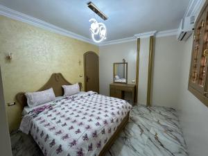 a bedroom with a large bed in a room at Fatah O 9 in Luxor