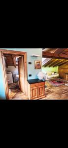 a living room with a table and a couch at Bilocale con vista sui monti in Pinzolo