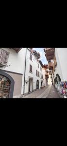 a picture of a street with a white building at Bilocale con vista sui monti in Pinzolo