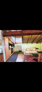 a living room with a couch and a table at Bilocale con vista sui monti in Pinzolo