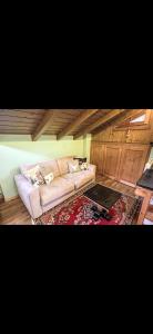 a living room with a couch and a table at Bilocale con vista sui monti in Pinzolo