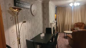 ein Wohnzimmer mit einem Tisch und einer Lampe in der Unterkunft Ansty view in Coventry