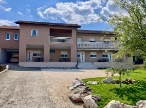 a large house with a yard in front of it at Crosshill apartments in Međugorje