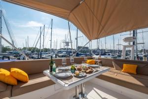 a table with food and drinks on a boat at 2BR Heated Yacht, Lymington Centre, Beautiful View in Lymington