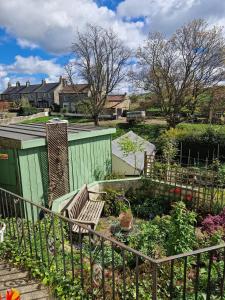 a garden with a bench and a fence at Littlebeck in Danby