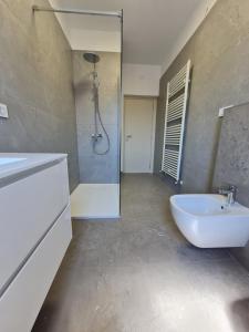 a bathroom with a tub and a sink and a shower at Rooms and Apartments Robert in Rovinj +38 photos