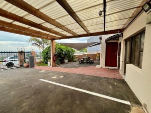 a patio with awning on top of a building at Lovista in Tygerberg Hills