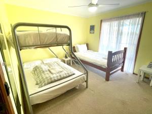 a bedroom with two bunk beds and a window at Blue Lagoon in American River