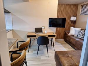 a living room with a desk with a laptop on it at Lovista in Tygerberg Hills