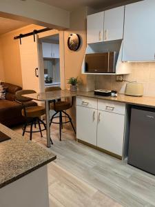a kitchen and living room with a table and a couch at Lovista in Tygerberg Hills