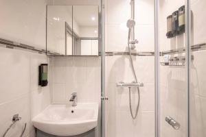 a white bathroom with a sink and a shower at The Burleigh palace in Cambridge +80 photos