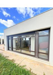 an image of a house with large windows at Villa sympa calme in Casablanca