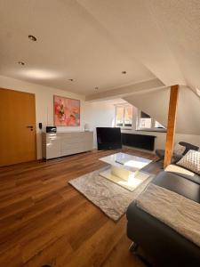 a living room with a couch and a table at Design Dachgeschoss Wohnung in Eilenburg