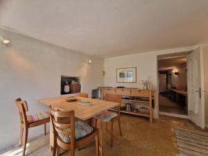 a kitchen and dining room with a wooden table and chairs at Le Coccinelle in Pallerone