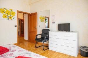 a bedroom with a dresser with a television on it at AppleCat in Rome