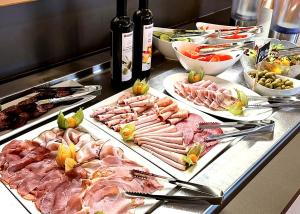 a buffet with many different types of meats and vegetables at Landhotel Maiergschwendt inkl Chiemgaukarte in Ruhpolding