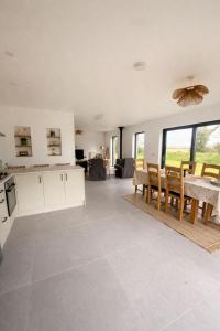 a kitchen and dining room with a table and chairs at Rosies Lodge in Kilkenny