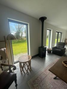 a living room with a fireplace and a couch and a table at Rosies Lodge in Kilkenny