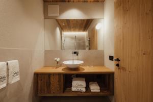 a bathroom with a sink and a mirror at Albergo Stella in La Villa +26 photos