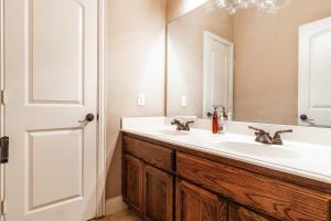 a bathroom with a white sink and a mirror at Osile Villa in DeSoto