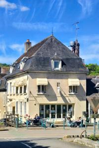 a building with people sitting outside of it at L eau douce in Ménétréol-sous-Sancerre