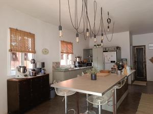a kitchen with a table and chairs in a room at Maison Talouma in Saly Portudal